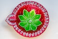 Closeup shot of a red and green Festival Diya Set for Decoration. Handmade Clay Diya for Diwali