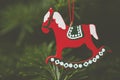 Closeup shot of a red horse Christmas tree ornament with a blurred background Royalty Free Stock Photo