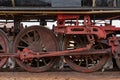 Closeup shot of the red metal wheels of a train during daytime Royalty Free Stock Photo