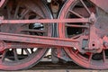 Closeup shot of the red metal wheels of a train during daytime Royalty Free Stock Photo