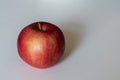 Closeup shot of a red shiny apple on a white background