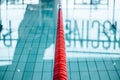 Closeup shot of a red swimming pool lane separator in the clear pool water