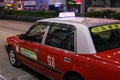 Closeup shot of a red taxi in the street Hong Kong at night Royalty Free Stock Photo