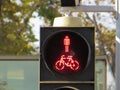 Closeup shot of red traffic light with a man with a bicycle Royalty Free Stock Photo