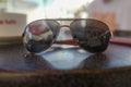 Closeup shot of reflective aviator sunglasses on a table