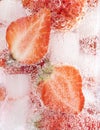 Closeup shot of a refreshing drink with a slice of strawberries and ice cubes Royalty Free Stock Photo