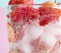 Closeup shot of a refreshing drink with a slice of strawberries and ice cubes Royalty Free Stock Photo