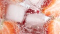 Closeup shot of a refreshing drink with a slice of strawberries and ice cubes Royalty Free Stock Photo