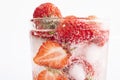 Closeup shot of a refreshing drink with a slice of strawberries and ice cubes Royalty Free Stock Photo