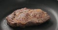 Closeup shot of ribeye steak frying on non stick pan Royalty Free Stock Photo