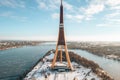 Closeup shot of the Riga Radio and TV Tower with a thin cloud background