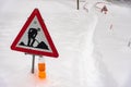 Closeup shot of a road works sign for construction in the snow