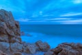 Closeup shot of a rocky beach and the blue sea on a cloudy day Royalty Free Stock Photo