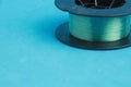 Closeup shot of a roll of nylon fishing line on a blue background