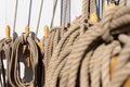 Closeup shot of the ropes tied on the wooden cleats on a sailing boat