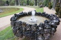 Closeup shot of a round fountain patterned with stone pieces in the gardens of Versailles. Royalty Free Stock Photo