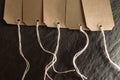 Closeup shot of a row of brown kraft tags on a black surface Royalty Free Stock Photo