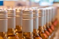 Closeup shot of rows of glass rose wines with silver caps on a liquor shelf