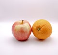 Closeup shot of a royal gala apple and an orange against a white background Royalty Free Stock Photo