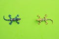 Closeup shot of rubber lizard toys isolated on a green background Royalty Free Stock Photo