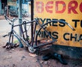 Closeup shot of a ruined bicycle in front of a repair station in Madurai, India