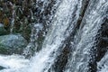 Closeup shot of rushing water flowing off a brick wall Royalty Free Stock Photo