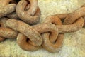 Closeup shot of a rusty iron chain on the gray background Royalty Free Stock Photo