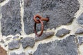 Closeup shot of a rusty iron ring on bluestone wall Royalty Free Stock Photo