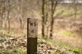 Closeup shot of a rusty metal 434 sign on a wooden pole in a park Royalty Free Stock Photo