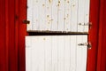 Closeup shot of rusty painted white red barn doors Royalty Free Stock Photo