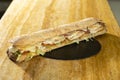 Closeup shot of a sandwich with baguette, chicken and tomato slices and