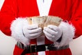 Closeup shot of Santa Claus holding euro bills Royalty Free Stock Photo