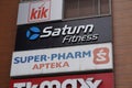 Closeup shot of Saturn Fitness and Super Pharm logos on the Galeria Malta shopping mall building