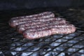 Closeup shot of sausages being grilled on a barbeque brazier
