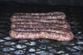 Closeup shot of sausages being grilled on a barbeque brazier