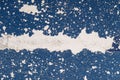 Closeup shot of scratched blue paint found on the wall of a building in a city Royalty Free Stock Photo