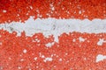 Closeup shot of scratched orange paint found on the wall of a building in a city Royalty Free Stock Photo