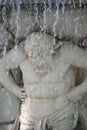 Closeup shot of a sculptured statue carrying fountain water in the garden in Aranjuez, Spain