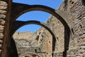 Closeup shot of semicircular arches at Loarre Castle under a blue sky, Seville, Spain