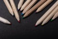 Closeup shot of a set of wooden color pencils on a black surface  - an art concept Royalty Free Stock Photo