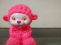 Closeup shot of a sheep doll with red color and red color ears and flowers on it. Royalty Free Stock Photo