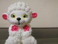 Closeup shot of a sheep doll with white color and red color ears and flowers on it. Royalty Free Stock Photo