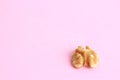 Closeup shot of a shelled walnut on pink background