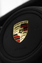 Closeup shot of the shining Porche logo on the steering wheel of a Porsche 911 Turbo