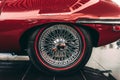 Closeup shot of a shiny wheel of a red retro car