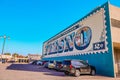 Closeup of the side of the Fresno Postage Stamp Mural with cars parked in front of it in the US