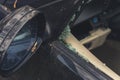 Closeup shot of side view mirror of a black car and smashed window glass. Accident and vehicle crash concept. Left