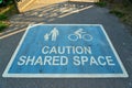 Closeup shot of a sign on the road warning about shared space for cyclists and pedestrians