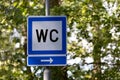 Closeup shot of a sign showing the direction of a toilet for women in Helsinki, Finland Royalty Free Stock Photo