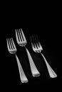 Closeup shot of silver forks isolated on black background Royalty Free Stock Photo